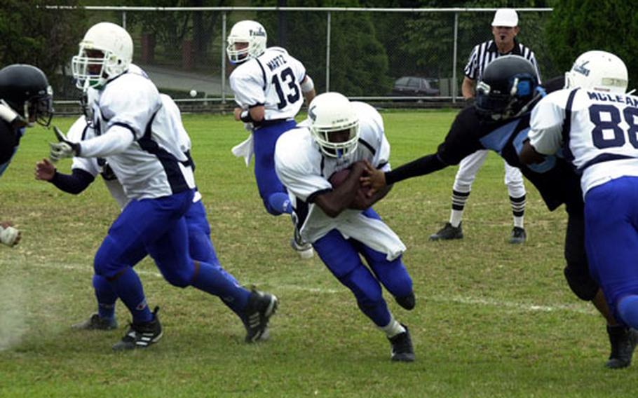 Seoul American Falcons running back David Smalls runs for daylight against the Osan American Cougars during Saturday’s DODDS-Korea game at Yongsan Garrison, South Korea.