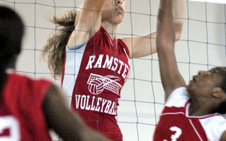 Ramstein&#39;s Kaylen Bannister towers over Kaiserslautern’s Deadre Green for a block during a match at Ramstein on Saturday.