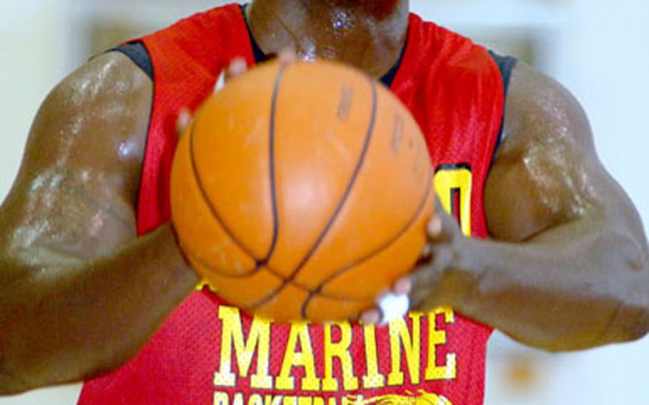 Tony Ellis of 3rd Marine Logistics Group puts up a foul shot against Navy during Wednesday’s Joint Military Athletic Conference basketball game at Kadena Air Base, Okinawa. 3rd MLG won 83-55.