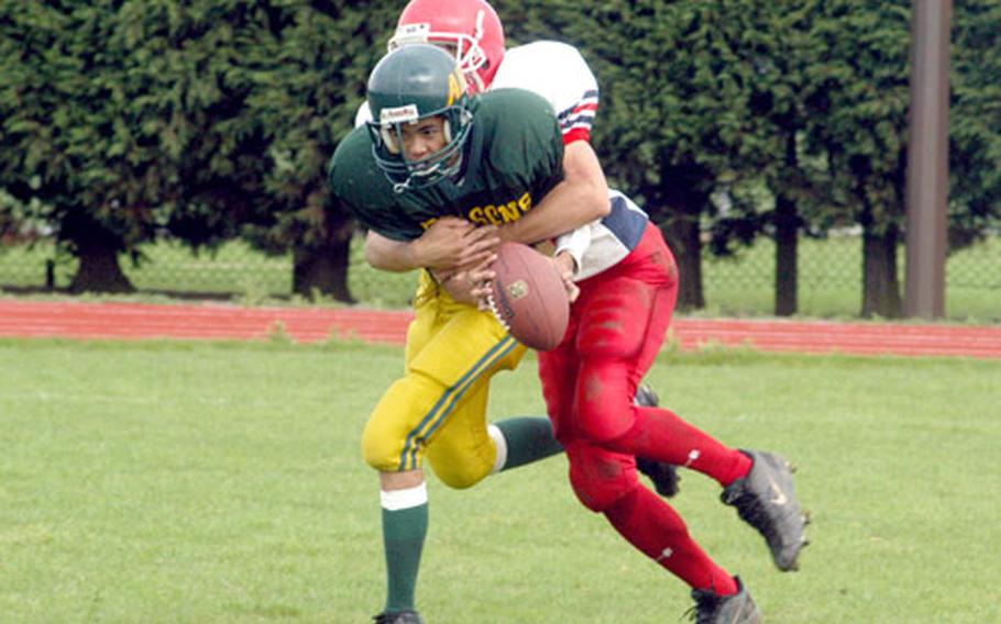 Menwith Hill’s Todd Moyer sacks Alconbury quarterback Jimmy Luong for a safety in the Mustangs’ 36-8 victory on Saturday.