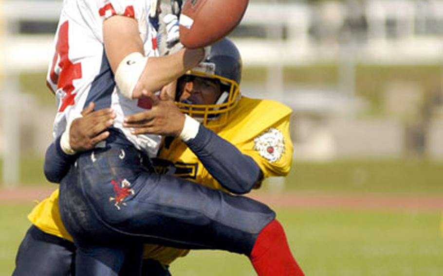 Heidelberg’s William Battle puts a hard hit on Chuck Pope of Lakenheath to break up a pass during the third quarter of the Lions’ 28-13 win Saturday.