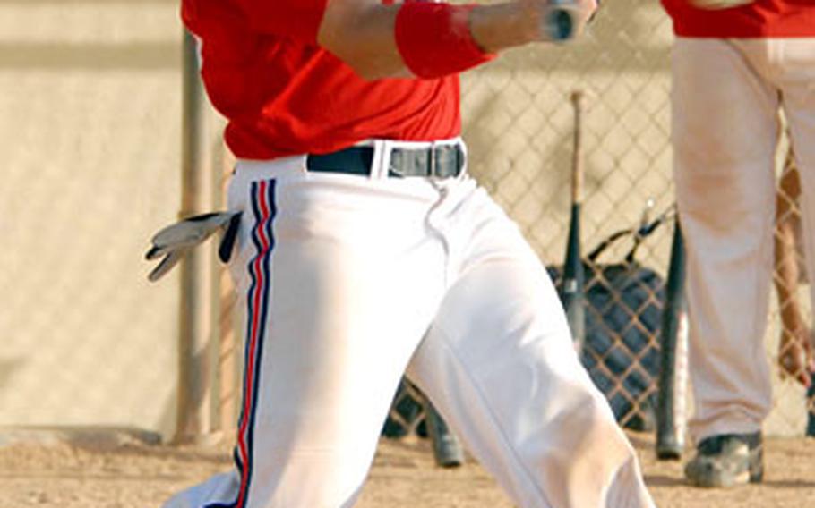 All-Air Force outfielder Kurt Tom of Okinawa’s American Legion drills a base hit against Naval Forces Okinawa on Saturday in the 12th Kadena Klassic Softball Tournament at Kadena Air Base, Okinawa. Legion won 21-4.