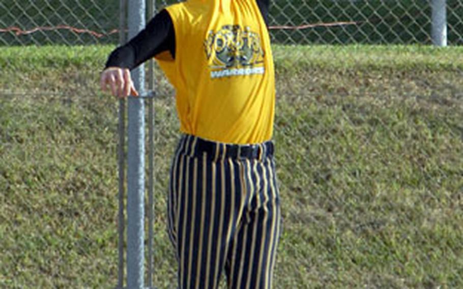 Brooks Veil of Japan’s Yokota Warriors robs an batter from Okinawa’s Benchwarmers batter with a catch at the fence on Saturday. Yokota won 34-6.