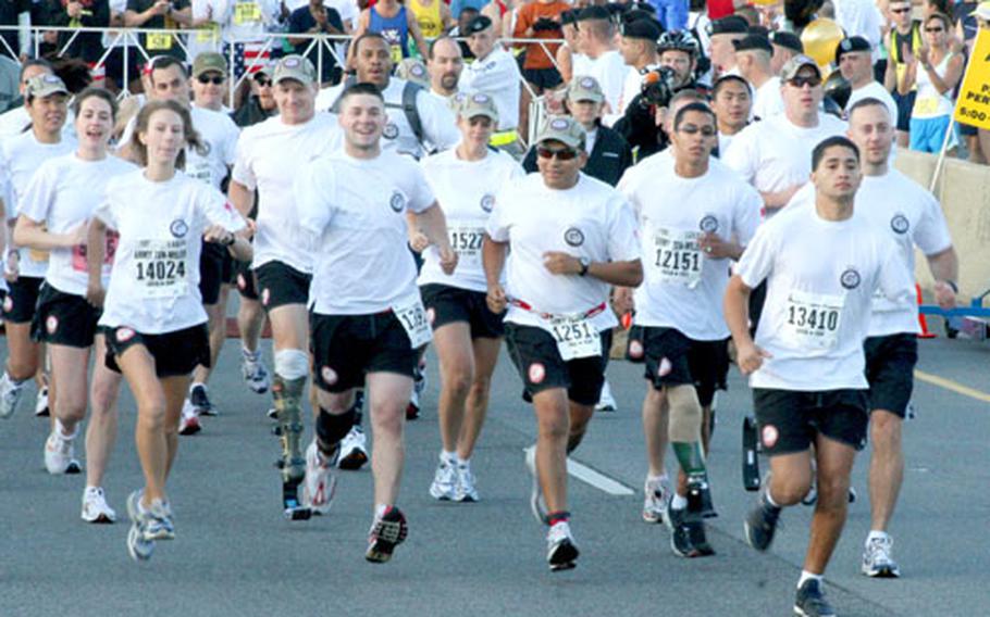 Runners from the Missing Parts in Action team break from the starting line in Sunday’s Army Ten-Miler at the Pentagon.