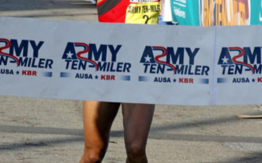 Alisa Harvey of Manassas, Va., crosses the finish line as the women’s champion in the 2006 Army Ten-Miler.