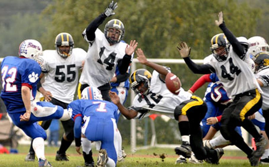 The Patch defense blocks an extra point attempt by Joel Smith during the second half of Patch’s game against Ramstein on Saturday.