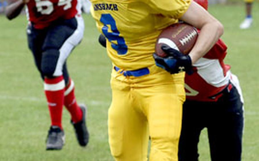 Ansbach’s Thomas Graham keeps Giessen’s Brett Jones at bay as he scores a touchdown during Ansbach’s 39-0 win on Saturday.