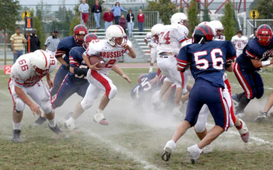 ISB junior running back Philip Freedman heads up field in a cloud of chalk Saturday during the Raiders’ 20-6 victory over Aviano in the regular-season finale for both teams.