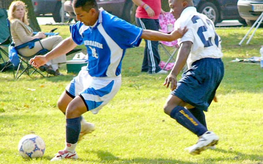 Wiesbaden’s Jose Lazcano fends off Heidelberg defender Mensah Dzediku during Heidelberg’s 3-1 victory in the 2006 U.S. Army Europe championship game Sunday at Schwetzingen, Germany.