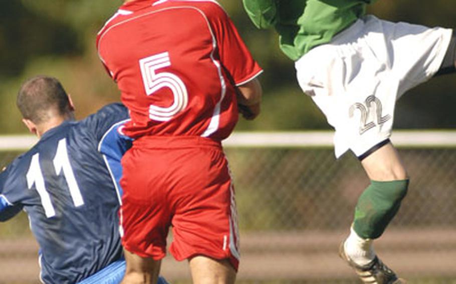 J.T. Sullivan from Spangdahlem makes a huge save over John Maynard, left, of Lakenheath during the first half.