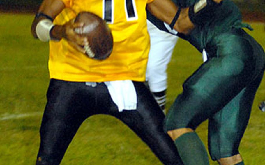 Kubasaki linebacker Boomer McCaw sacks Kadena quarterback Jon Robinson during the second game of the Okinawa Activities Council best-of-three football championship series at Camp Foster, Okinawa, on Oct. 20. Kadena beat Kubasaki 14-8 to sweep the series 2-0.