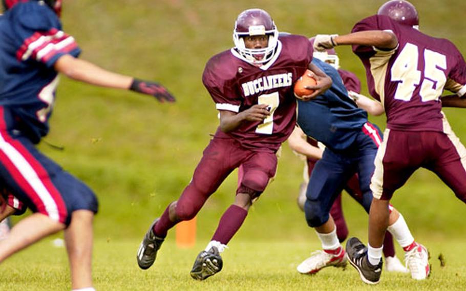 Baumholder’s True Davis slides through a hole in Aviano’s defense during the Saturday’s Division II playoff game at Baumholder.