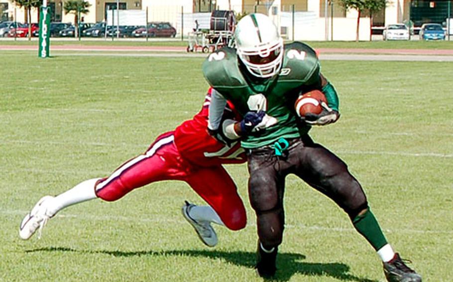 Naples tailback B.J. Taylor tries to shake a tackler during a 40-7 victory against Aviano on Oct. 7. Taylor got one of of the Wildcats’ four rushing touchdowns in the game.