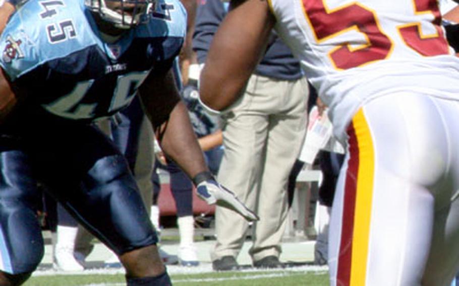 Ahmard Hall keeps an eye on Redskins linebacker Marcus Washington.