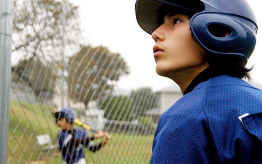 Kyle Fajardin, 12, watches his Oohira Fighters teammates practice at the Negishi Housing Area field Sunday.