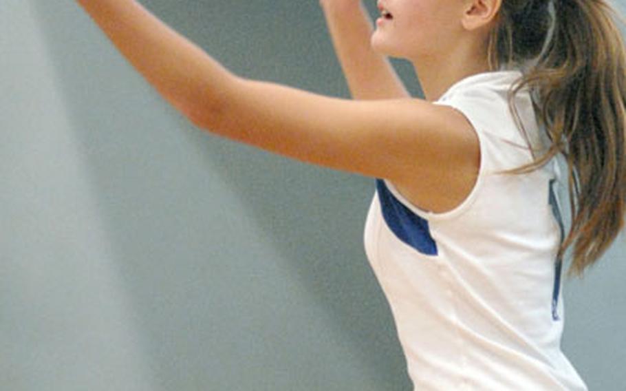 Nathalie Graves from Milan makes the winning serve during the third game against Alconbury on Friday.