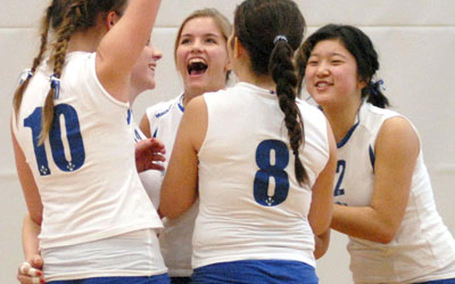 Milan players celebrate their Game 3 victory Friday over Alconbury, moving them closer to the Division IV girl’s volleyball championship finals.