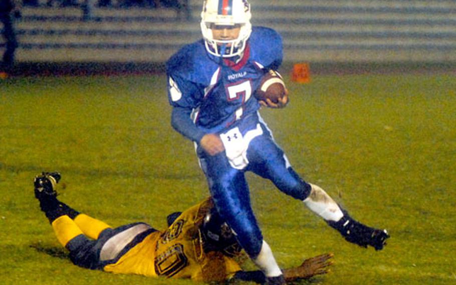 Ramstein’s Aaron Jones dodges Heidelberg’s Shon Fisher and heads for the end zone in the DOODS-Europe Division I football title game on Saturday night in Baumholder, Germany. Ramstein beat Heidelberg 26-7 to capture the crown.