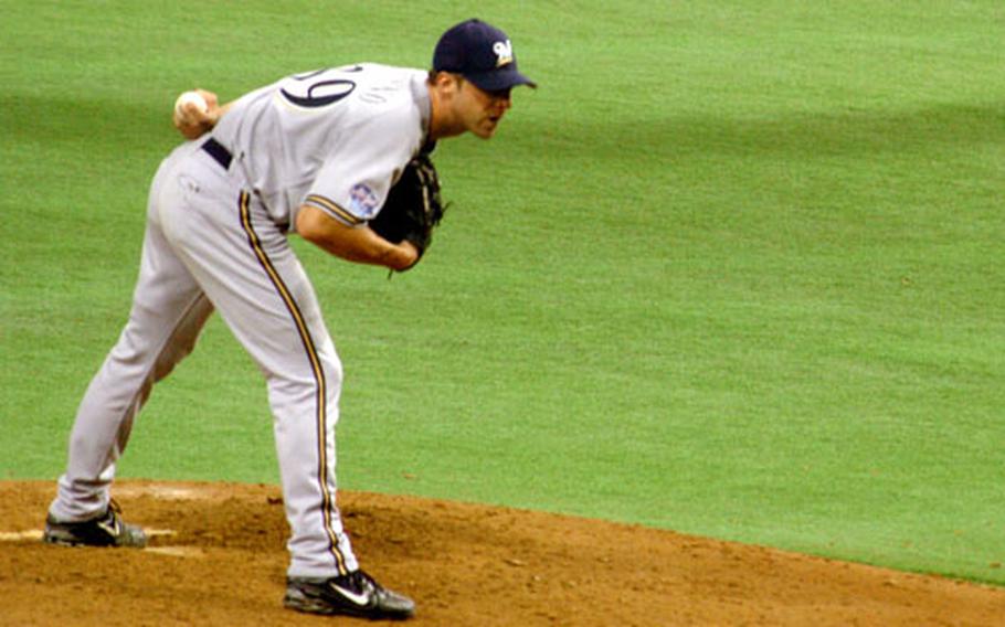 Chris Capuano from the Milwaukee Brewers pitches during an exhibition game in Tokyo Dome on Saturday.