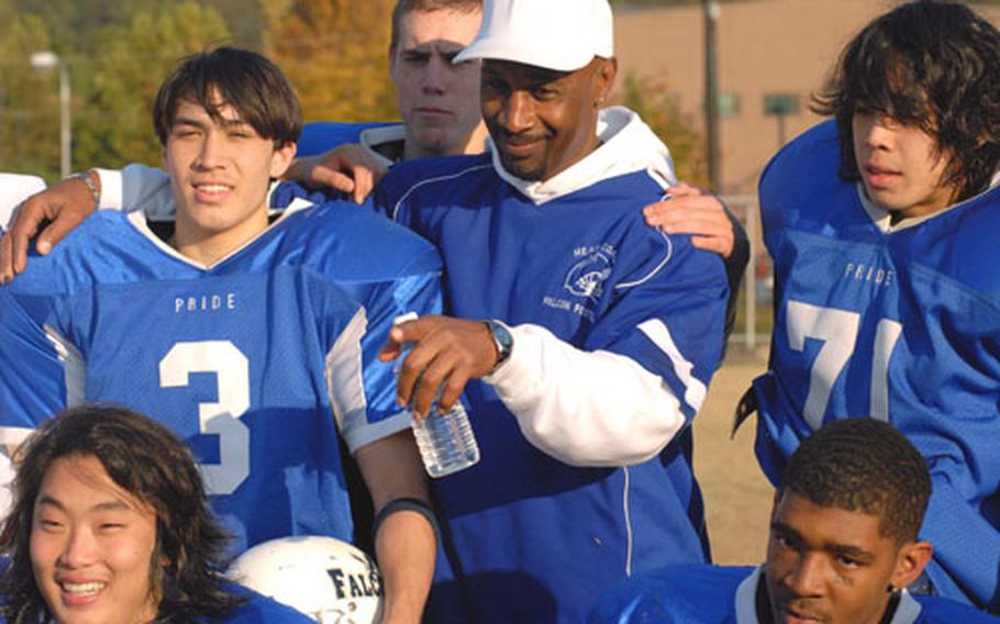 Seoul American football coach Julian Harden is surrounded, from lower left, by seniors Daniel Kim (99), Daniel O&#39;Connor (3), Charles Jones (back), Matt Bronson (71) and Sean Brown, cornerstone players in the Falcons&#39; first Far East Class AA football championship team.