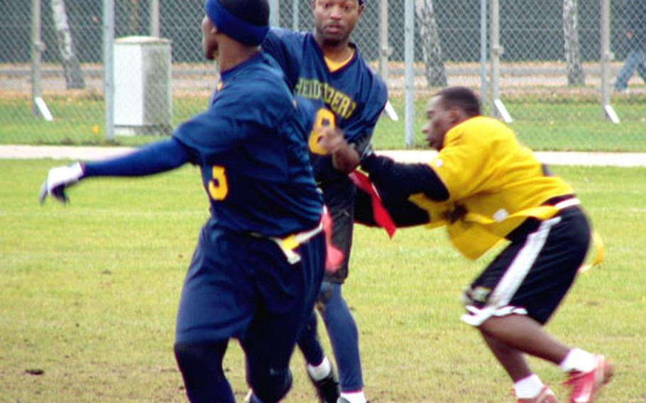Heidelberg quarterback Jamel Grier, under pressure from Wiesbaden rusher Jarard Smith, attempts to dump the ball off to Demetrius Bennett during Heidelberg's 21-20 IMCOM-Europe flag football championship game Sunday in Bamberg, Germany.