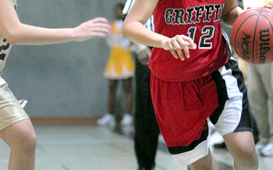 Elisha Darby of Giessen drives past a Baumholder defender on the way to the basket late in the fourth quarter at Baumholder on Saturday. Darby scored 20 points to lead Giessen over Baumholder, 49-38.