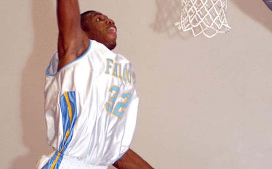 Bryan Simpson of the Kadena Falcons goes up for the slam dunk over B.J. Ziemann of the Okinawa Suns during Tuesday's championship game of the Joint Military Athletic Conference at Risner Fitness & Sports Complex, Kadena Air Base, Okinawa. Simpson led six players in double figures with 15 points as the Falcons beat the Suns 93-85.