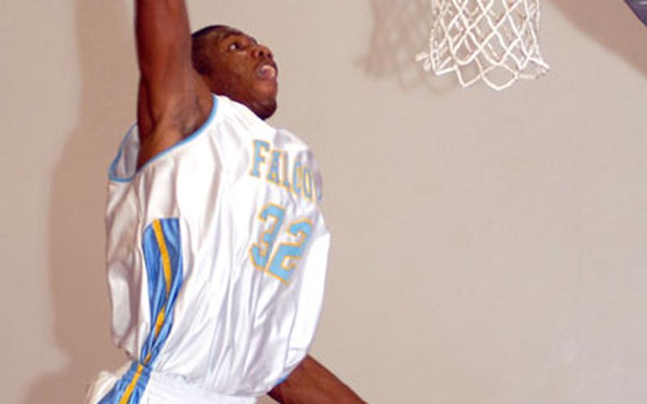 Bryan Simpson of the Kadena Falcons goes up for the slam dunk over B.J. Ziemann of the Okinawa Suns during Tuesday&#39;s championship game of the Joint Military Athletic Conference at Risner Fitness & Sports Complex, Kadena Air Base, Okinawa. Simpson led six players in double figures with 15 points as the Falcons beat the Suns 93-85.