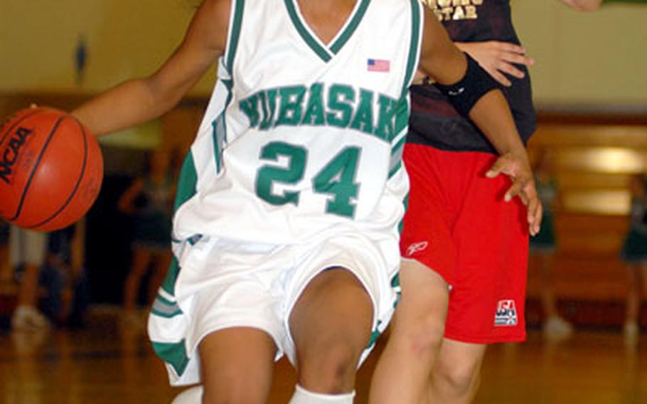 Kubasaki’s Mechi Fletcher drives past Reiko Uchida of Urasoe Commercial High School Friday at Camp Foster, Okinawa. Fletcher scored a team-high 25 points as Kubasaki earned its first victory over a Japanese team this season 87-74.