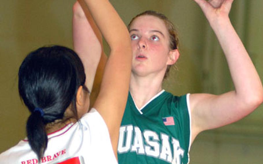 Kubasaki's Sarah Brubaker puts up a shot over Ayumi Gakiya of Futenma during Saturday's game at Camp Foster.