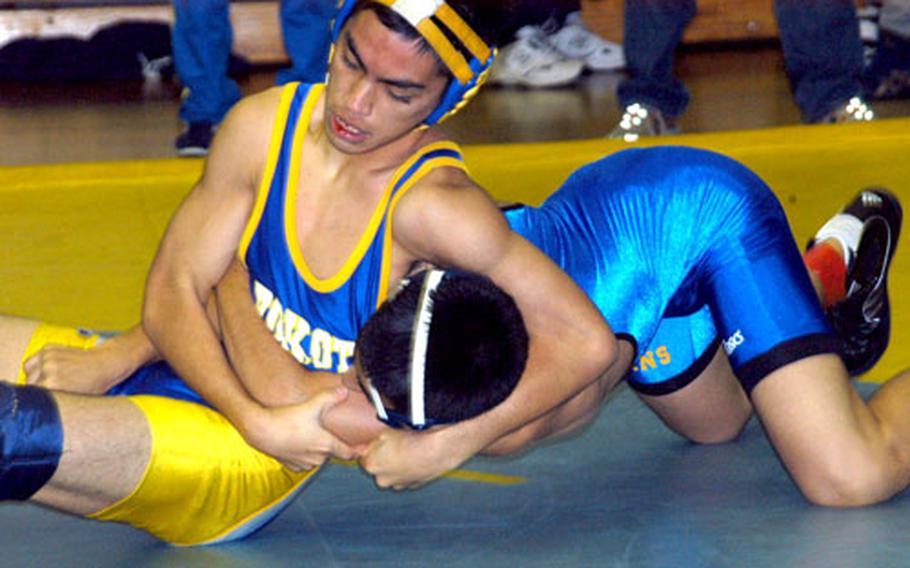 Yokota 122-pounder Nick Guzman works a headlock on Joey Buccilli of St. Mary&#39;s International during his semifinal victory in Saturday&#39;s Kanto Plain Invitational at Yokota High School, Japan.