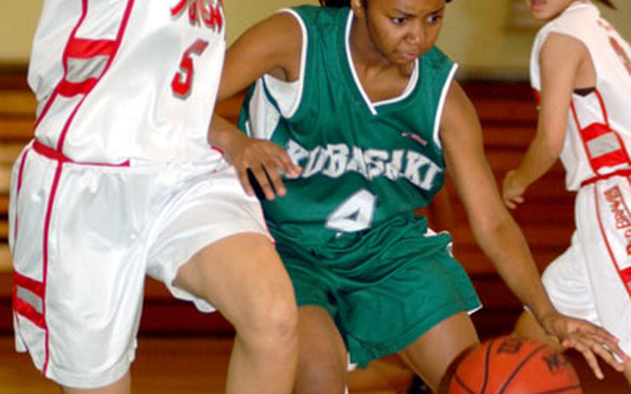 Ashley Parmer of the Kubasaki Dragons tries to drive past Mika Nakayama of the Futenma Red Brave during Saturday&#39;s game at Camp Foster, Okinawa. Futenma won 89-53.