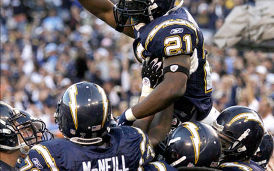 San Diego Chargers running back LaDainian Tomlinson is hoisted by teammates after scoring his 29th touchdown of the season, breaking the NFL single-season record, in the Chargers 48-20 victory over the Denver Broncos in San Diego on Sunday.