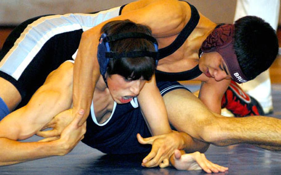 Osan American 129-pounder Edwin Rodriguez takes early command over Michael Beckwith of Seoul American. Rodriguez rallied for a 2-1 decision (4-6, 5-4, 3-3 last point).