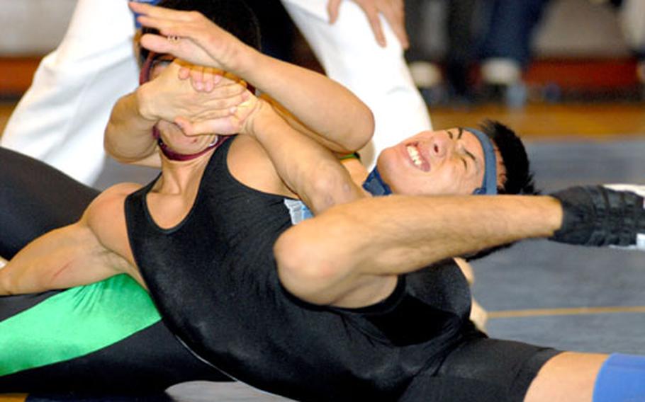 Taegu American 129 pounder Josh Mendez tries to tilt Edwin Rodriguez of Osan American. Mendez won a 2-0 decision (3-2, 4-2).