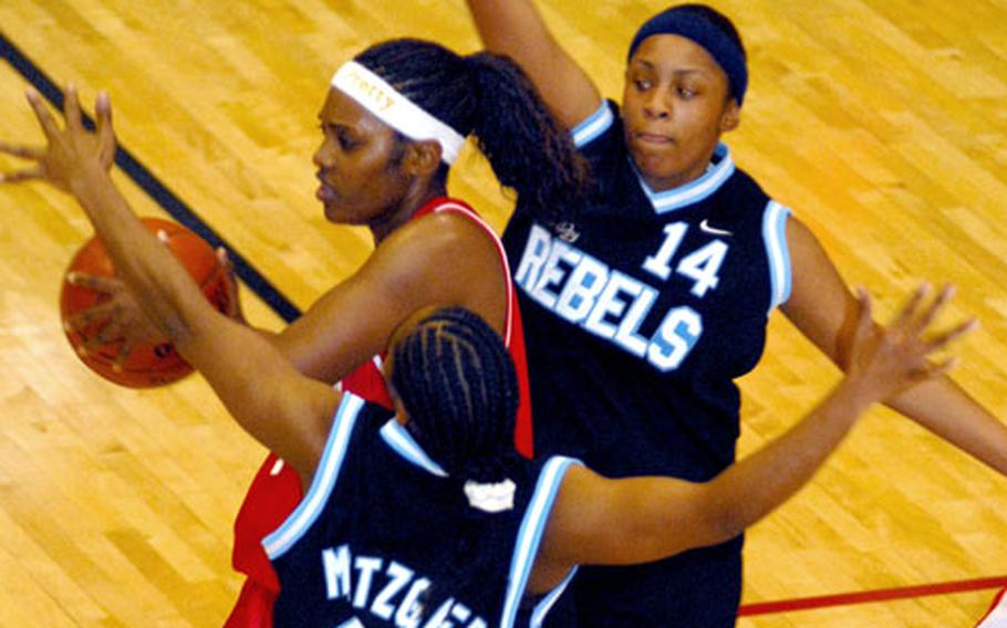 Seven-time All-Armed Forces swingman Evevetta Crawford of the Okinawa Mystics looks to pass between Yongsan Runnin&#39; Rebels defenders Detrina Soto (10) and Tasha Crawford (14) during Monday&#39;s double-elimination playoff game. Despite suiting up just five players, the Mystics routed the Rebels, 90-65.