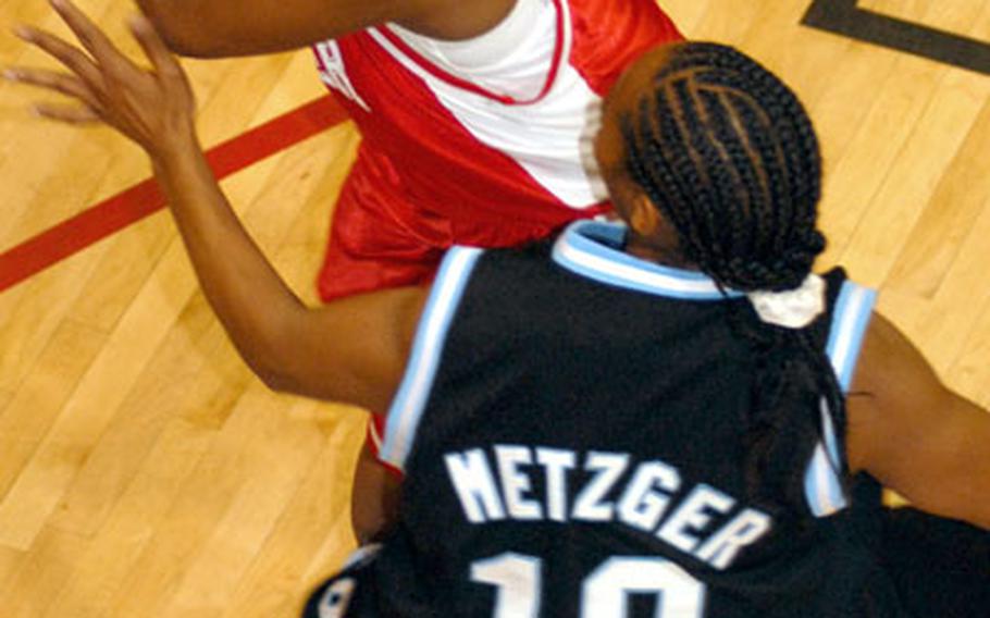 Tachaka Moore of the Okinawa Mystics looks to pass the ball past Yongsan Runnin&#39; Rebels defender Detrina Soto (10).