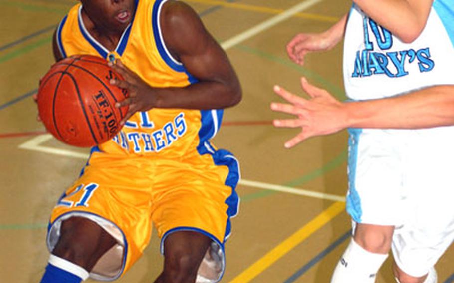 Yokota junior guard Anthony McNeill pulls up to pass as St. Mary's International junior guard Tobi Taniguchi defends during Friday's pool play game in the inaugural New Year's Classic at Yokota High School. Yokota won 55-51.