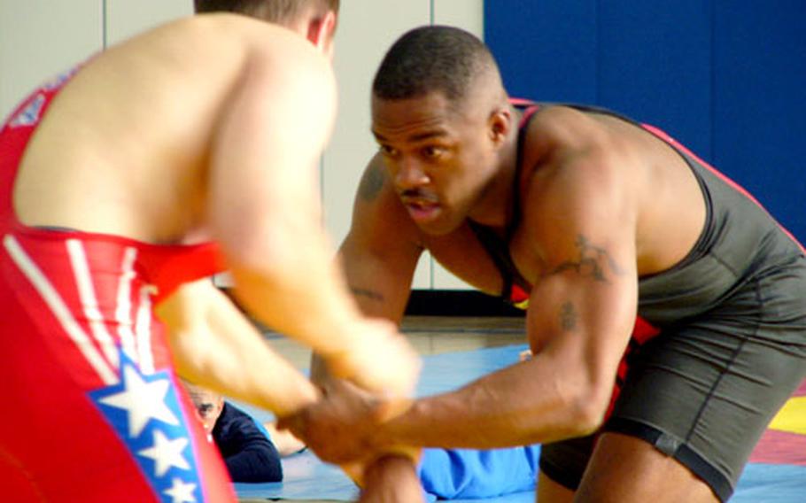World Class Athlete Program wrestler Charles Daniels of Ansbach (right) looks for an opening against Kevin Sanger of Kaiserslautern during the 211-pound bout at the U.S. Forces Europe freestyle wrestling tournament Sunday in Vaihingen, Germany. Daniels defeated Sanger 5-2 en route to a gold medal.