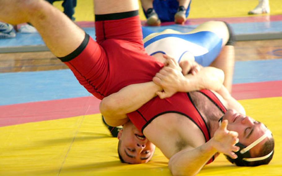 Richard Pabon of Darmstadt (bottom) executes a gut-wrench Sunday in attempting to turn Matt Alden of Baumholder during the pair&#39;s 163-pound bout at the U.S. Forces Europe freestyle championships at Vaihingen, Germany. Pabon, who recorded two falls en route to the gold medal, pinned Alden in 2:52.