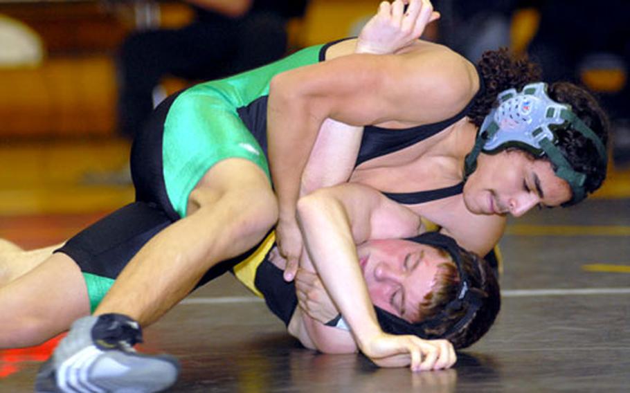 Kubasaki 129-pounder Josh Bales gets Kadena's Ben Breazile in a head-in-arm hold during Thursday's Okinawa Activities Council season-opening dual meet at the Panther Pit, Kadena High School, Kadena Air Base, Okinawa. Bales pinned Breazile in 1 minute, 10 seconds and the Dragons snapped a nine-meet losing streak to the Panthers, beating Kadena 39-20.