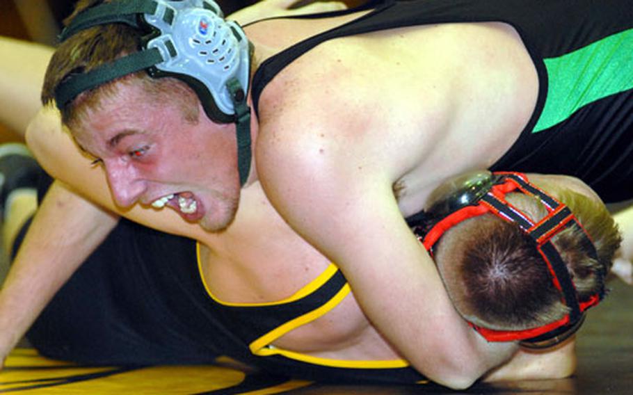 Kubasaki 168-pounder Jake Haynes wrenches the shoulders of Kadena&#39;s Matt Correia to the mat during Thursday&#39;s Okinawa Activities Council season-opening dual meet at the Panther Pit, Kadena High School, Kadena Air Base, Okinawa. Haynes pinned Correia in 1 minute, 30 seconds and the Dragons snapped a nine-meet losing streak to the Panthers, beating Kadena 39-20.