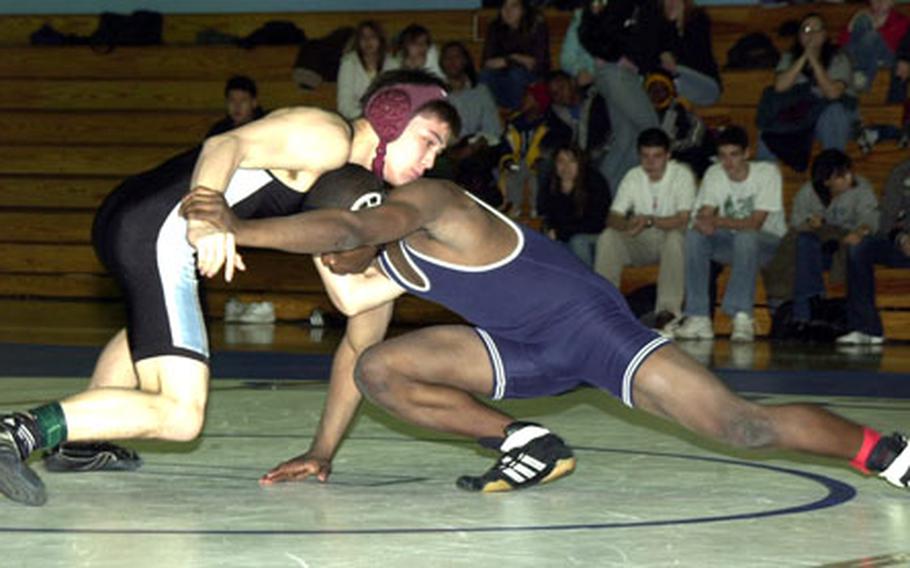 Osan American Cougars 141-pounder Tucker Rhodes, top, tries to avert a takedown by Demetrius Johnson of the Seoul American Falcons during Saturday&#39;s Department of Defense Dependents Schools-Korea wrestling tri-meet at Falcon Gym, Seoul American High School, Yongsan Garrison, South Korea. Johnson pinned Rhodes in 26 seconds and the Falcons won the dual meet 31-25, remaining unbeaten in eight dual meets so far this season.