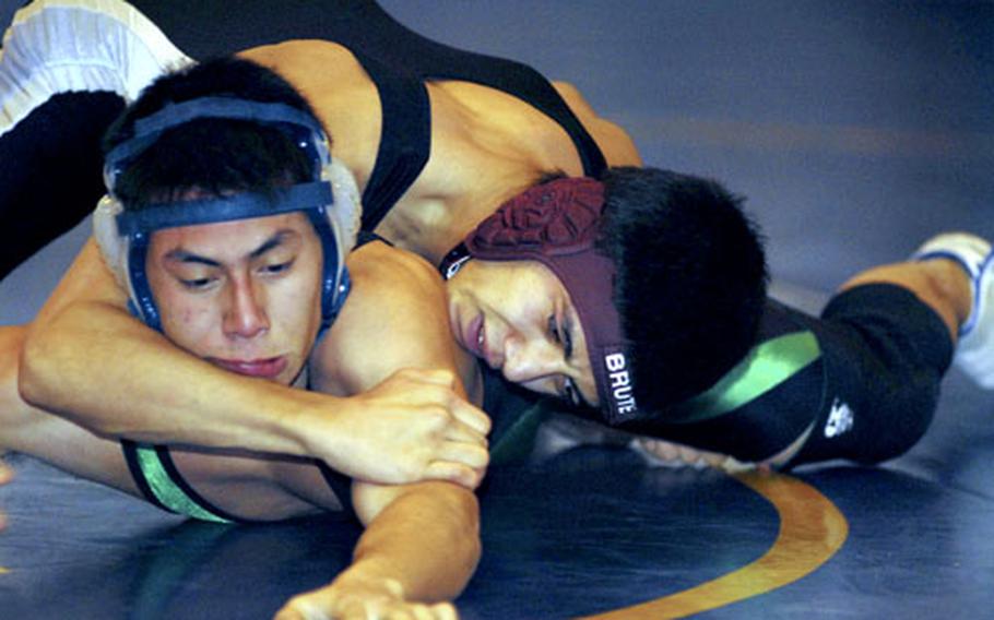 Edwin Rodriguez of Osan American (top) grapples with Josh Mendez of Taegu American during a DODDS-Korea tri-meet at Taegu American School, Camp George, South Korea on Dec. 16. 2006. Mendez decisioned Rodriguez 2-0 (3-2, 4-2) in the 129-pound bout. Taegu won 33-21, part of the Warriors’ effort to build a real program after years of fielding tiny rosters and only winning two Far East tournament bronze medals in the last seven years.