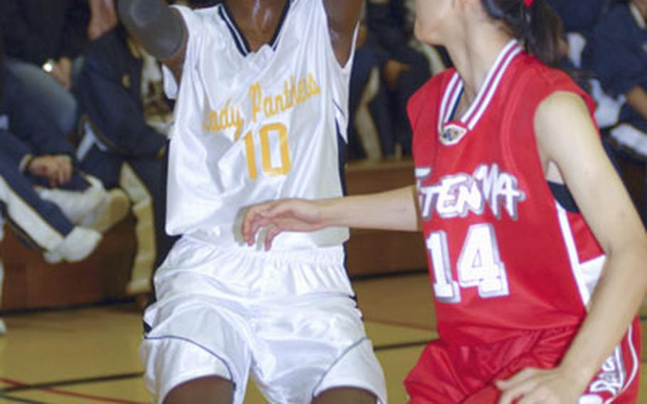 Kadena guard Zori Drew (10) looks to shoot over Yumeno Miyagi of the Futenma Red Brave during the girls championship game in the Okinawa-American Basketball Shootout at Kadena High School.