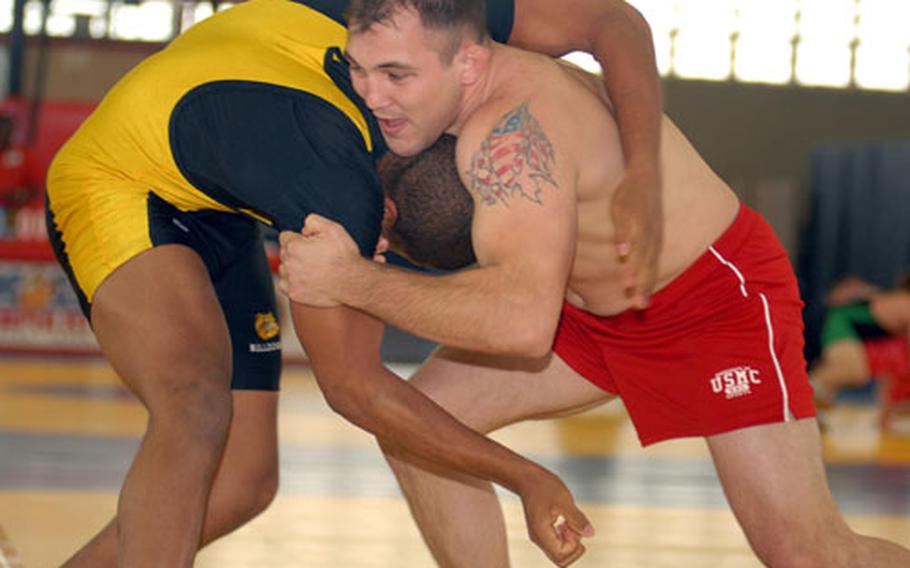 Jacob Clark, right, a 10-time All-Armed Forces gold medalist and six-time United States champion, grapples with Charlie Alston in a 210-pound bout during Saturday&#39;s Foster Open Wrestling Tournament at the Foster Field House, Foster Athletics Complex, Camp Foster, Okinawa. Clark won by superior decision in his final competition before transferring from Okinawa to his new duty station, Cherry Point Air Station, N.C.
