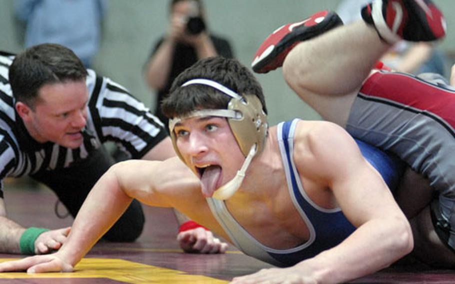 Ramstein 145-pounder Jon Peden concentrates as he applies pressure to Giessen’s Travis Mitchell on Saturday in Baumholder, Germany. Peden pinned Mitchell en route to winning his weight class.