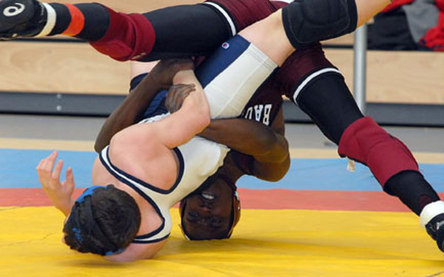 Despite being on his head, Baumholder&#39;s Michael Smith, back, sends Bitburg&#39;s Kyle Wells to the mat in an opening day match at the DODDS-Europe wrestling final in Wiesbaden, Germany, on Friday. Smith won the 140-pound match.