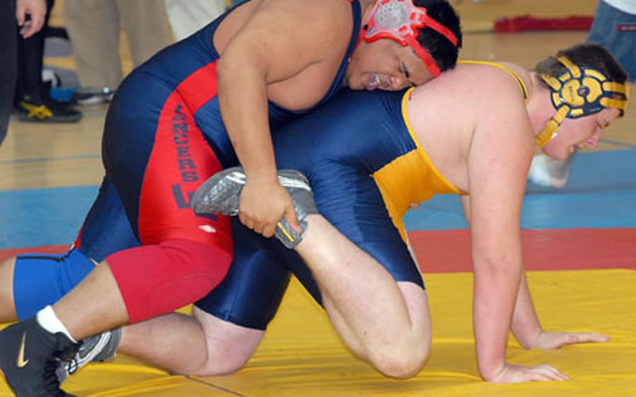 Chris Santos of Lakenheath, left, seems to have the better of Heidelberg&#39;s Jordan Fackler in a 285-pound match at the DOOD-Europe wrestling finals in Wiesbaden. Fackler turned the tables on Santos and won the match.