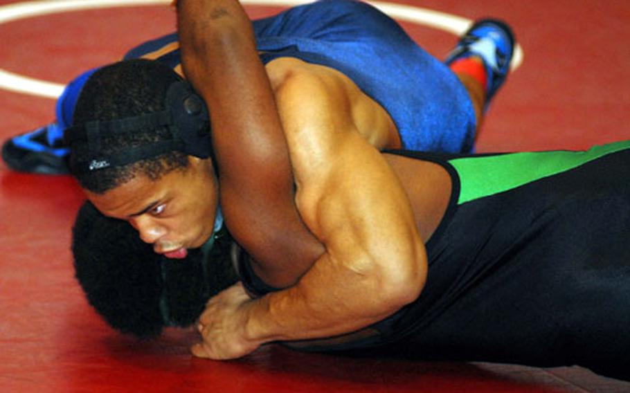 Justin Stokes of Seoul American wrenches the shoulders of Kubasaki&#39;s Ricky Jones to the mat in the 180-pound championship bout during Friday&#39;s individual freestyle playoffs in the 2007 DODDS-Pacific Far East High School Wrestling Tournament at Old Thew Gym, Yokosuka Naval Base, Japan. Stokes pinned Jones in 3 minutes, 10 seconds, clinching the team title for the Falcons, who scored 62 points to 58 for 20-time champion Kubasaki.